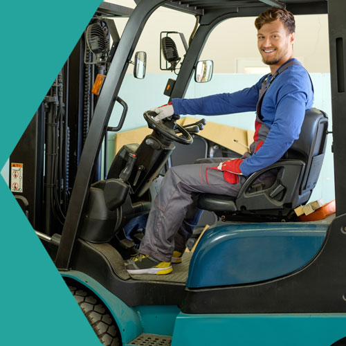 Young man driving forklift truck in Bolton