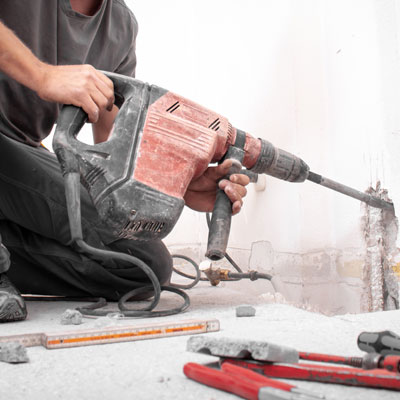 Man using power tools on construction site in Bolton